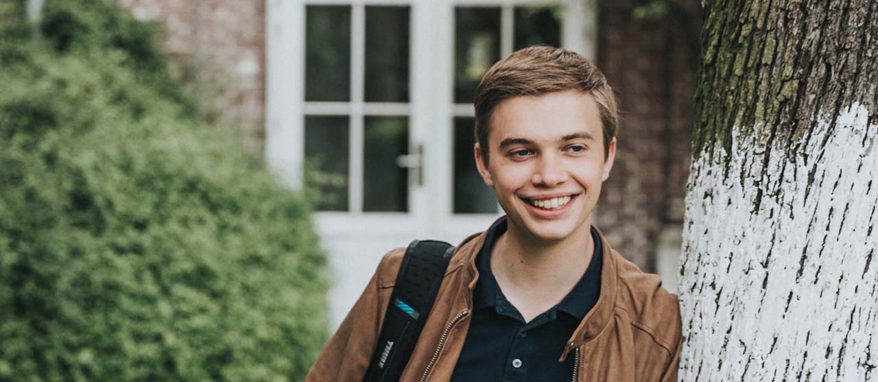 Een student uit de bachelor lager onderwijs in de binnentuin van HOGENT-campus Ledeganck.